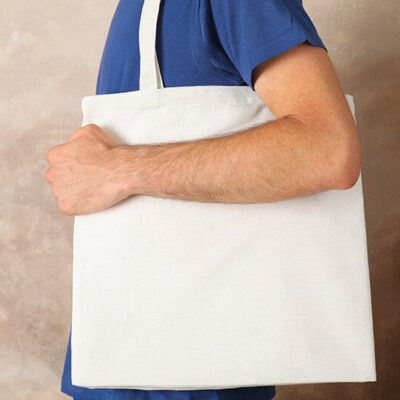young-man-holding-tote-bag-against-brown-backgroun-2022-02-08-03-18-54-utc